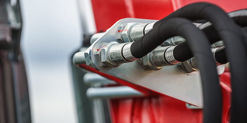 Image of hydraulic lines on a machine to represent Diesels, Hydraulics, Carriage Supplies which are popular product categories in Plain Communities Business Exchange.