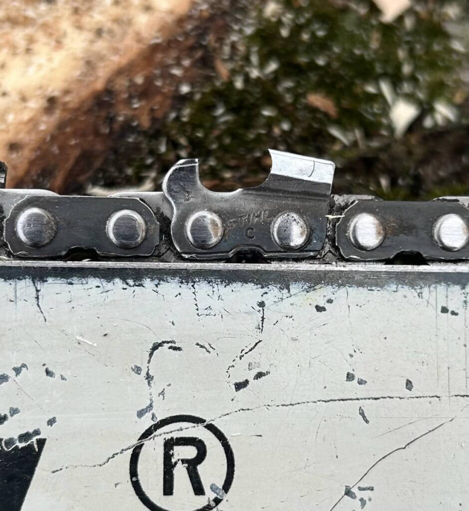 Close-up of a chainsaw chain cutter filed with a deeper hook