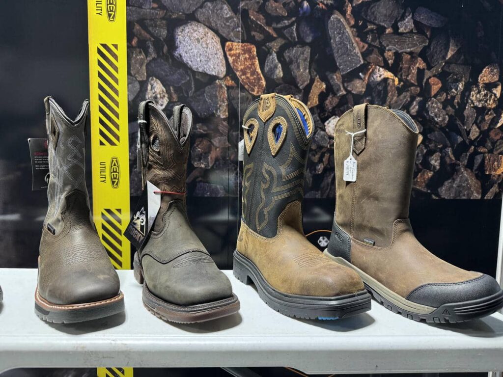 Row of rugged work boots displayed inside the Midwest Utility Source trailer